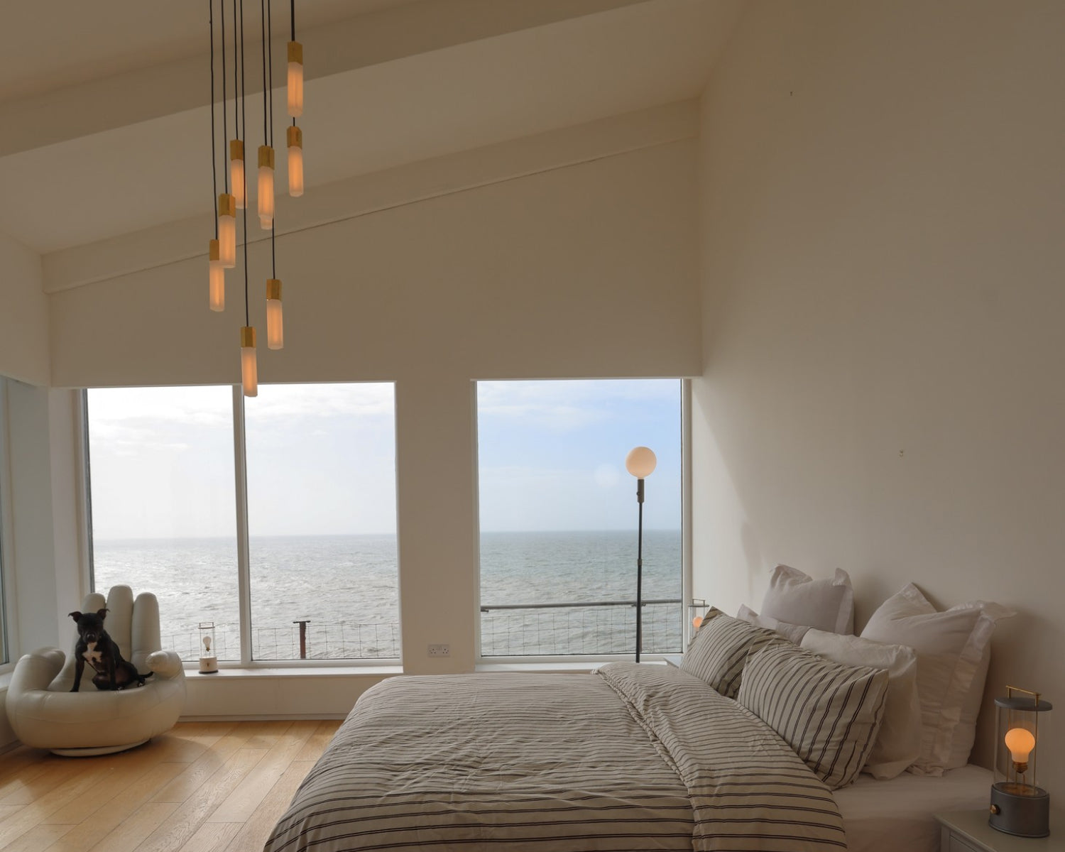 Basalt Nine Pendant, Poise Floor Lamp, and The Muse Portable Lamp in a coastal bedroom