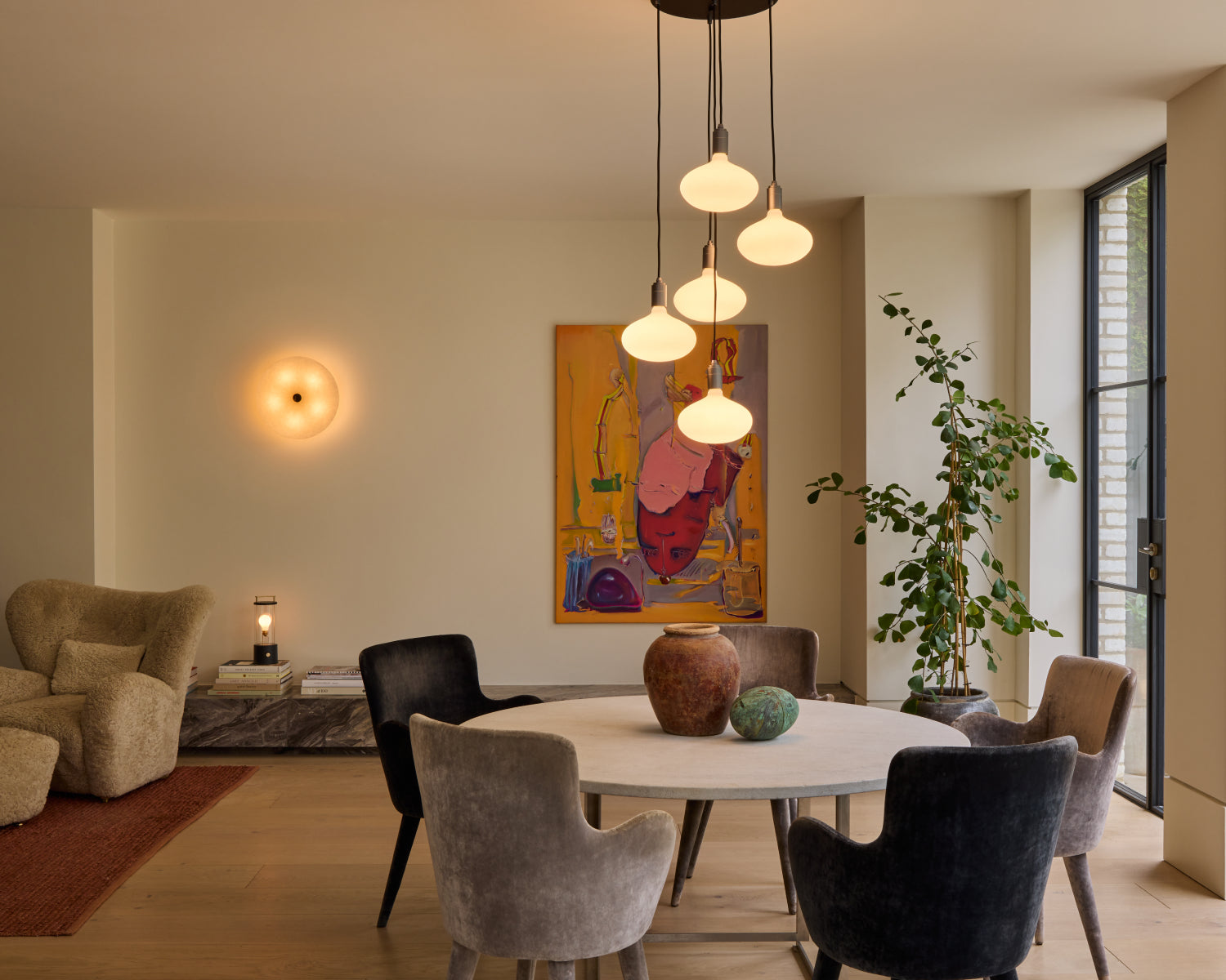 Five Pendant with Oval bulbs and Magma wall light in an open dining room setting