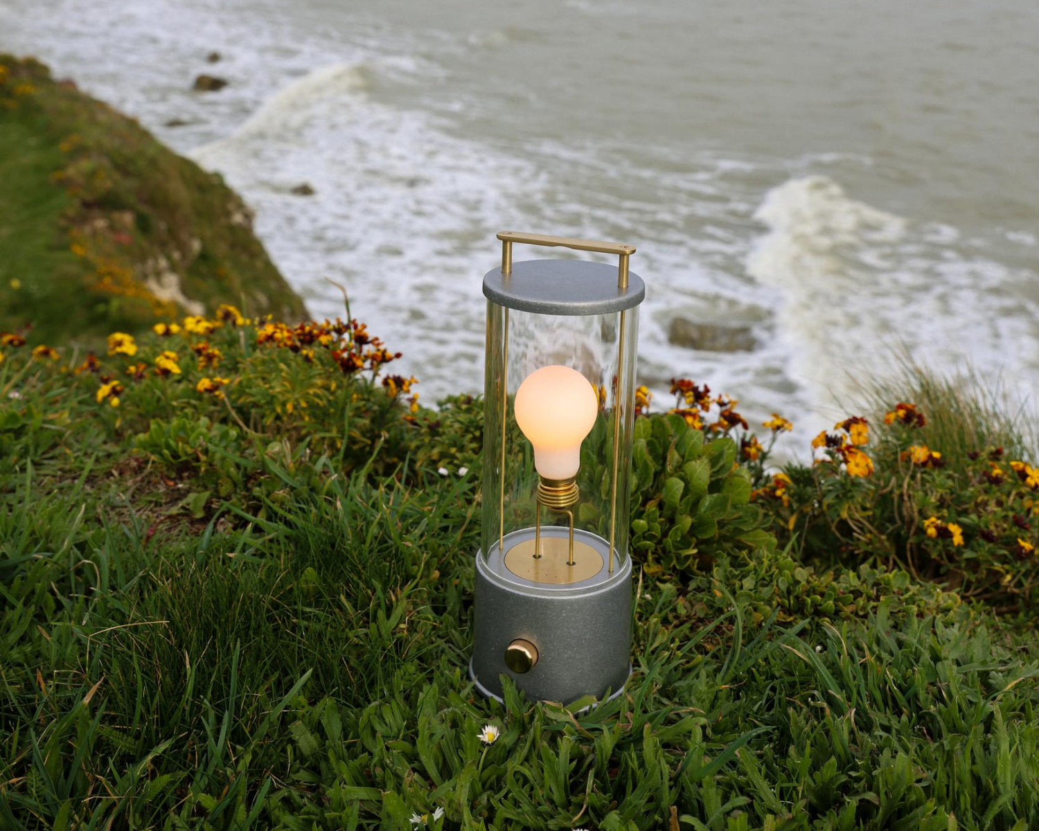 The Rugged Muse Portable Lamp, a weatherproof version of our bestselling portable light, outside along the coast