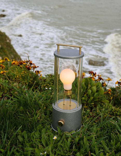The Rugged Muse Portable Lamp, a weatherproof version of our bestselling portable light, outside along the coast