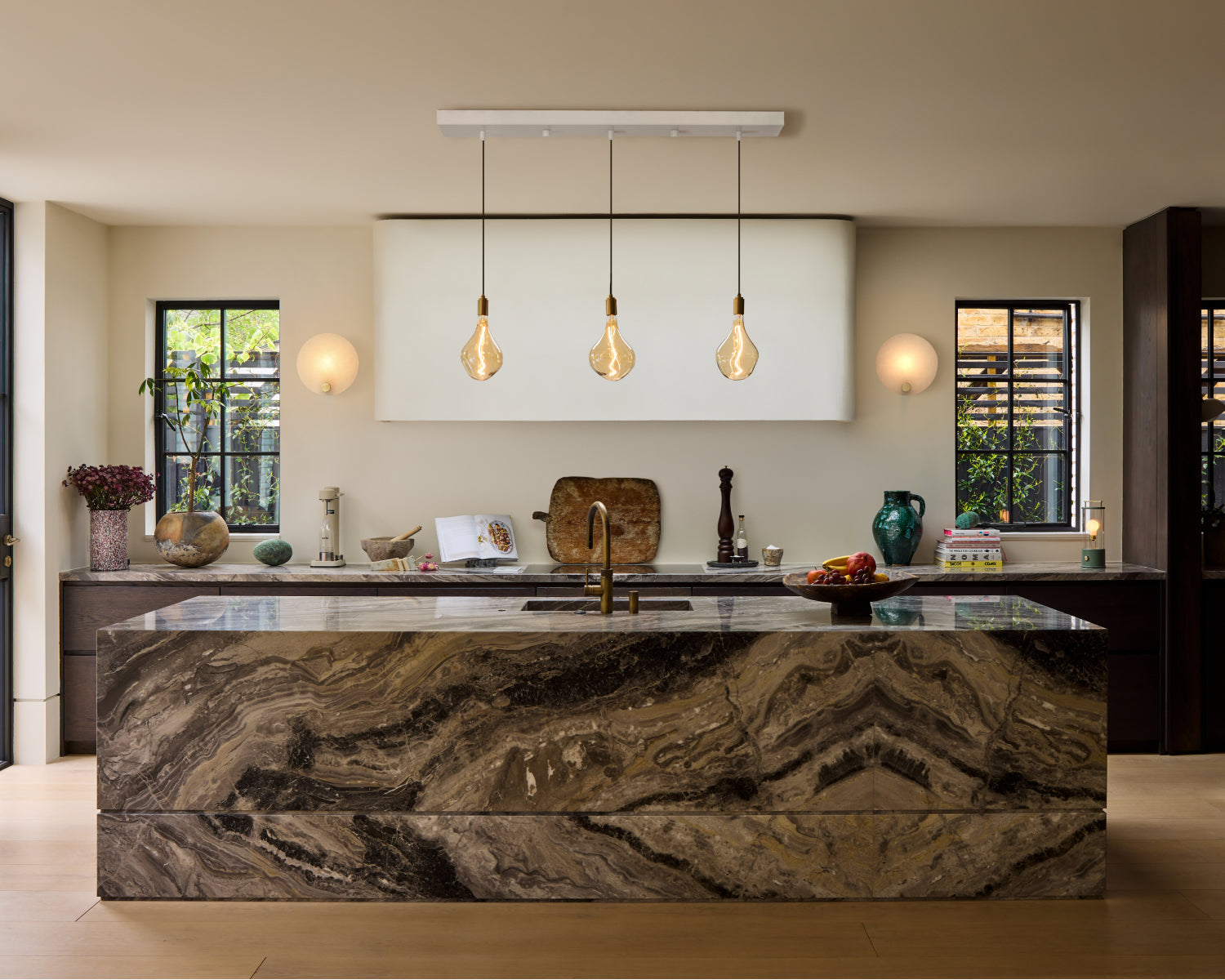 Pendant lights and wall lights in an open-plan kitchen