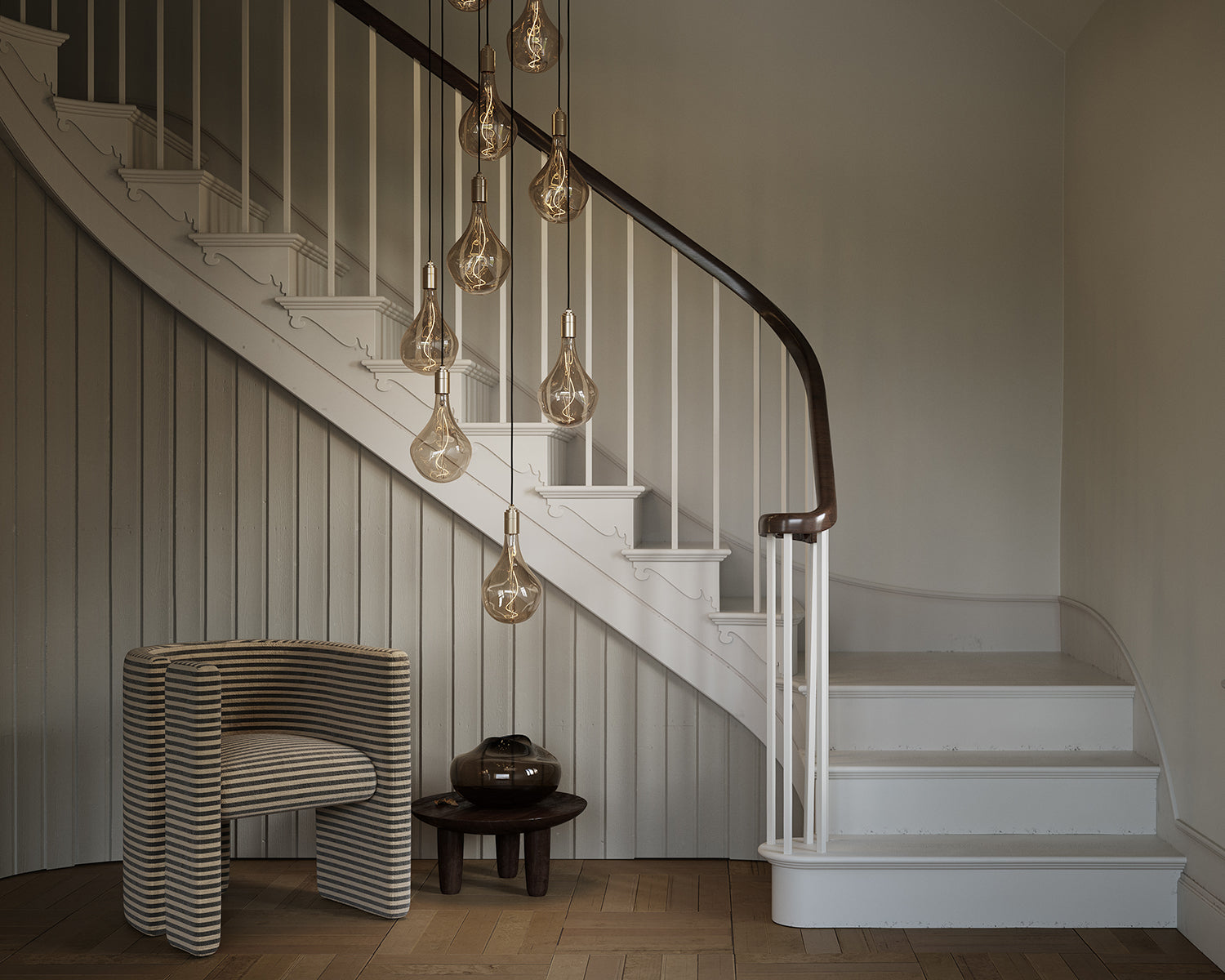 Nine pendant statement light in hallway near staircase