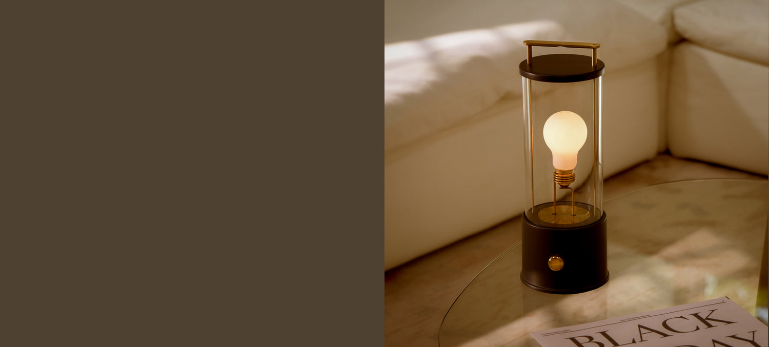 The Muse Portable Lamp in Hackles Black on coffee table in living room as part of Tala's Black Friday campaign.