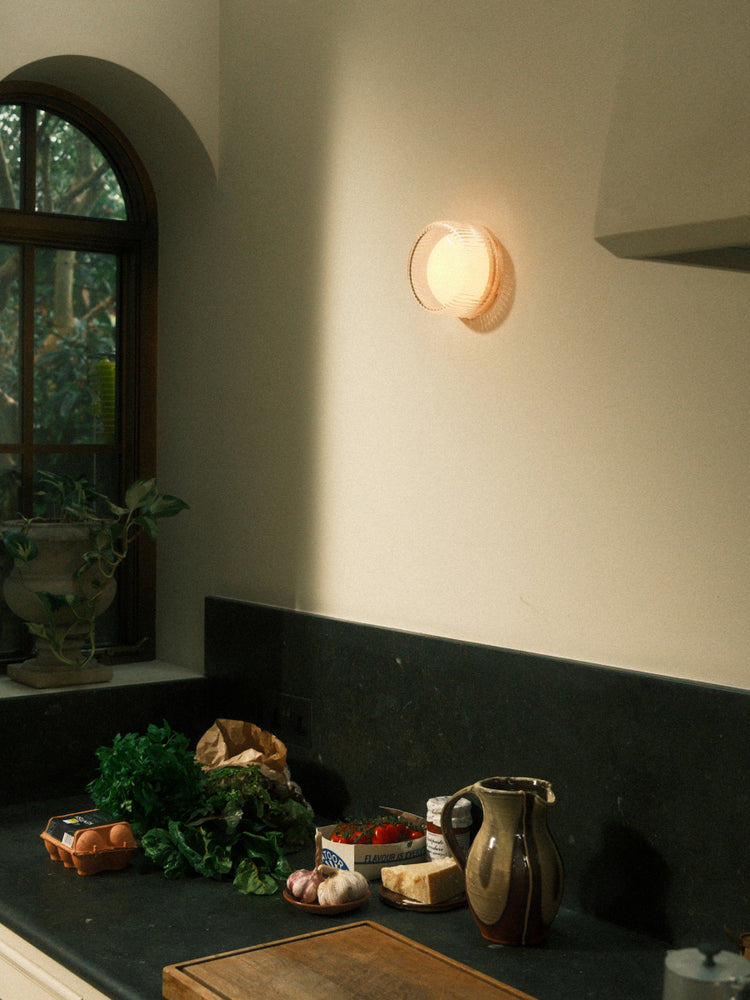 Firth Wall Light by Tala: an IP65-rated puck light mountable on a wall or mirror. Fit with Dim-to-Warm technology, Firth provides a perfect glow indoors or outdoors.
